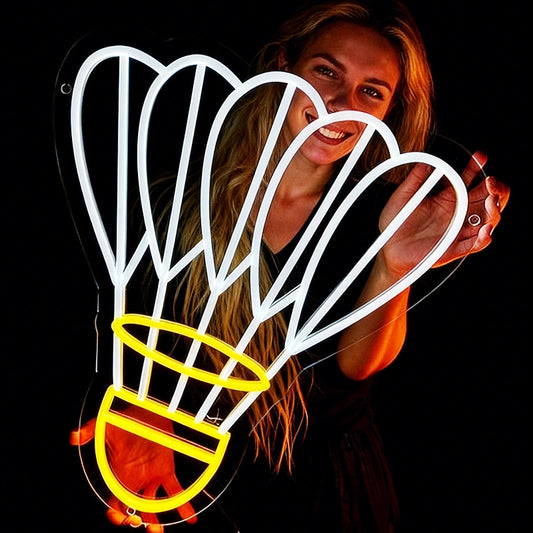 Person holding a neon shuttlecock light with lemon yellow and white color in a dark background
