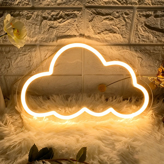 Warm White cloud-shaped neon light on a textured surface with a flower and green leaves.