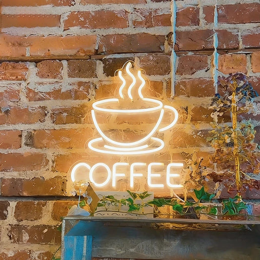 Neon sign of a warm white color coffee cup with steam against a brick wall.