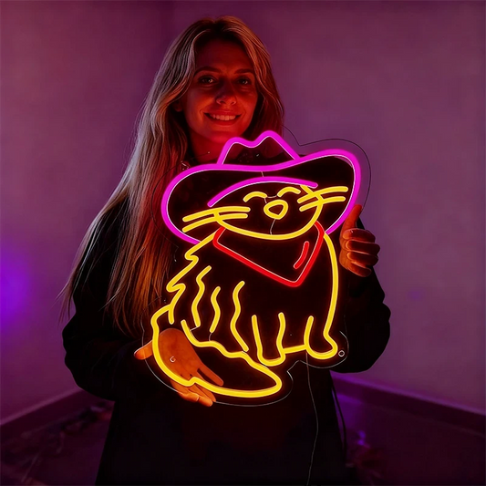 Woman holding a neon sign of a cat in a cowboy hat against a purple background