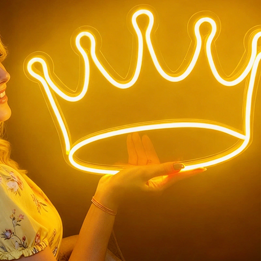Neon crown light with lemon yellow color held by a person against a dark background