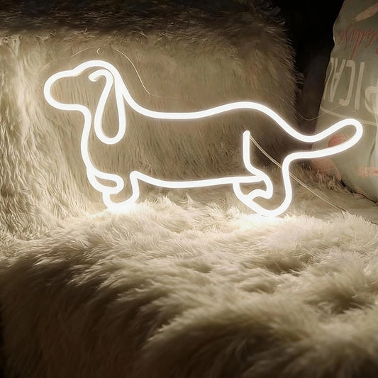 Neon wite light shaped like a dachshund on a fluffy surface