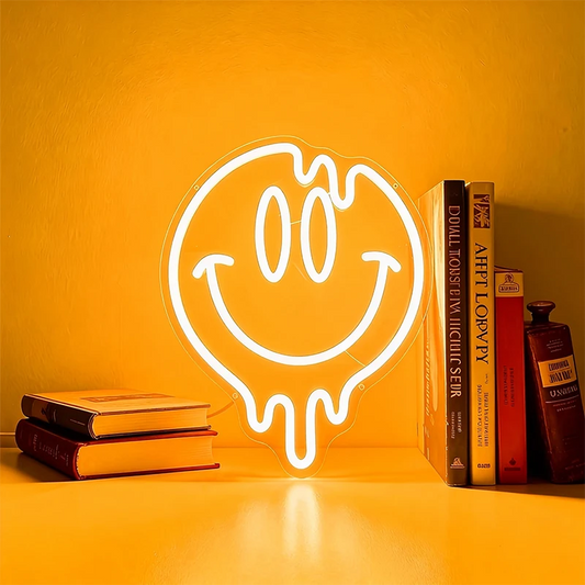 Neon light shaped like a smiley face with a drooling mouth on a warm white background.