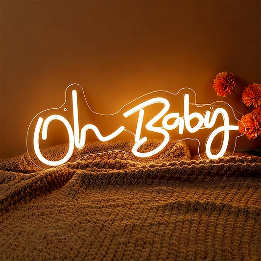 Neon sign with 'Oh Baby' text on a textured surface with flowers.