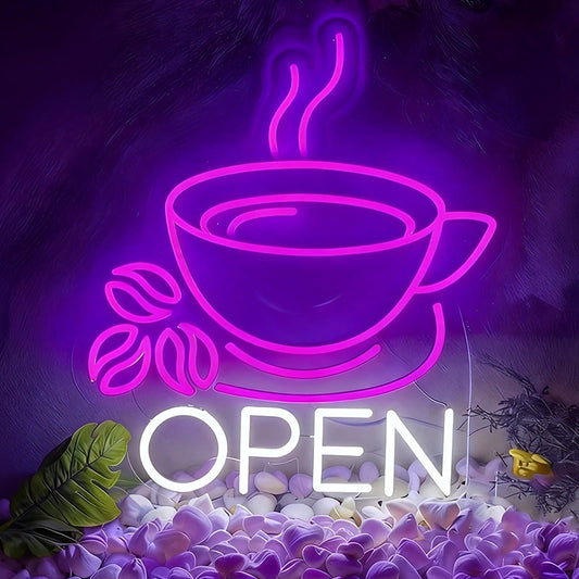 Neon sign of a coffee cup with steam and 'OPEN' text, glowing purple, on a decorative background.