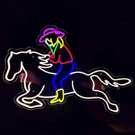 Neon sign of a cowboy on a horse against a black background
