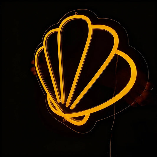 Neon sign shaped like a shell on a black background