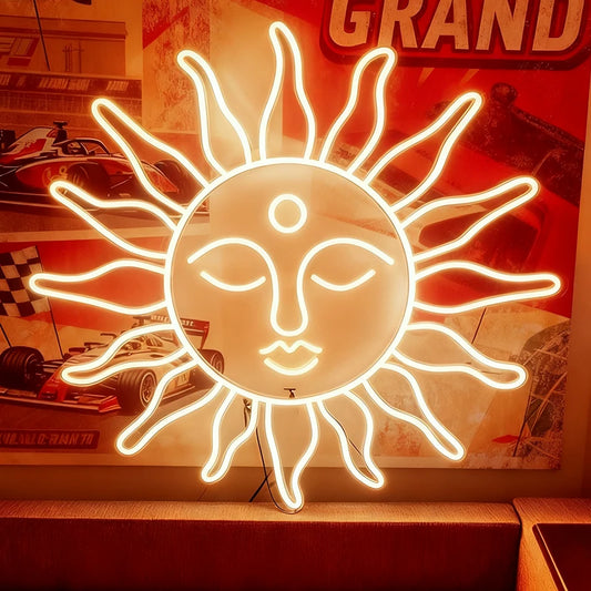 Warm white neon sun-shaped light fixture with face design in a room with posters and decor.
