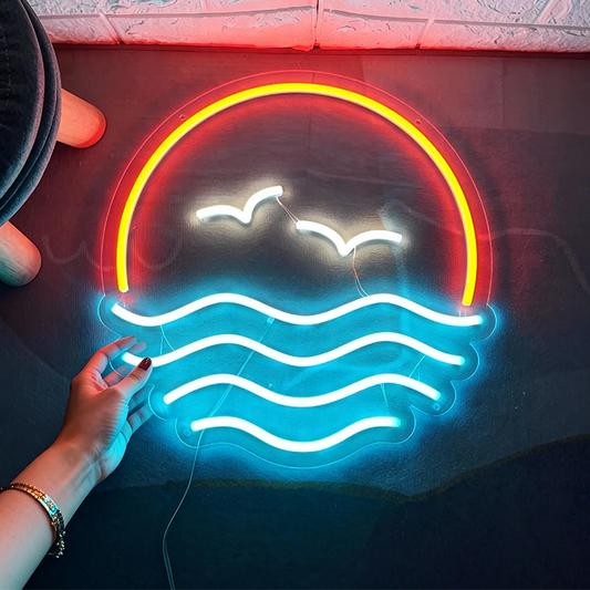 Neon sign with orange, white, and ice blue lights on a dark surface.