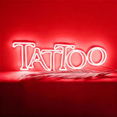 Neon sign with 'Tattoo' text on a red background