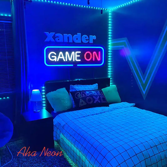 Neon-lit bedroom with 'Xander Game On' sign and gaming-themed decor.