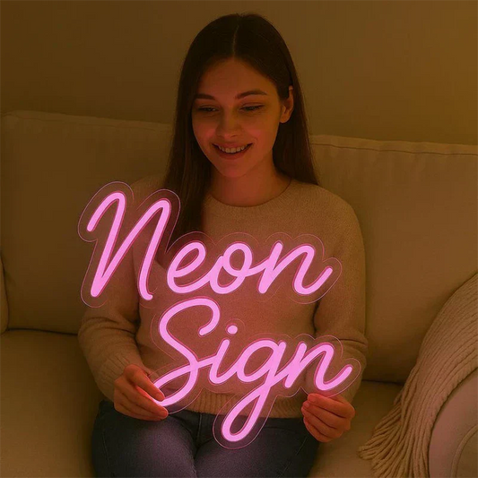 Person holding a neon sign with 'Neon Sign' text in a warm indoor setting