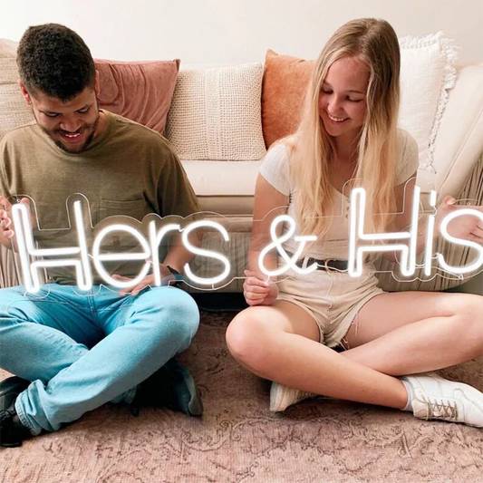 Man and woman sitting on a couch with 'Hers & His' text overlay