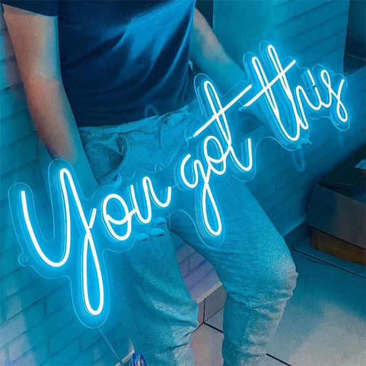 Neon sign with 'You got this' text in a casual setting