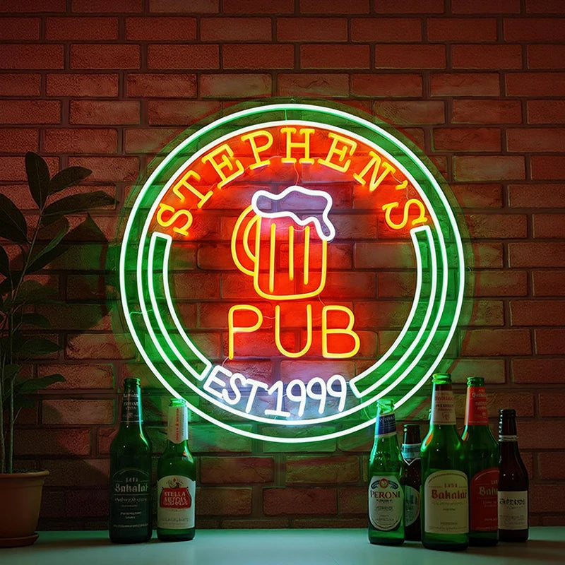 Neon sign for 'Stephen's Pub' with beer bottles in front of a brick wall.