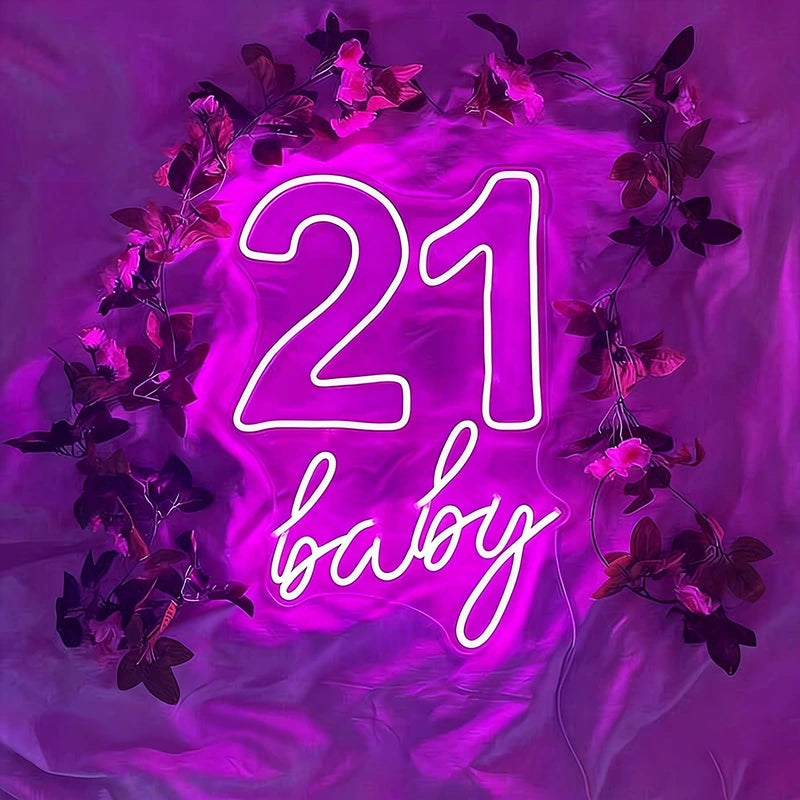 Neon sign with '21 baby' text surrounded by purple flowers on a purple background
