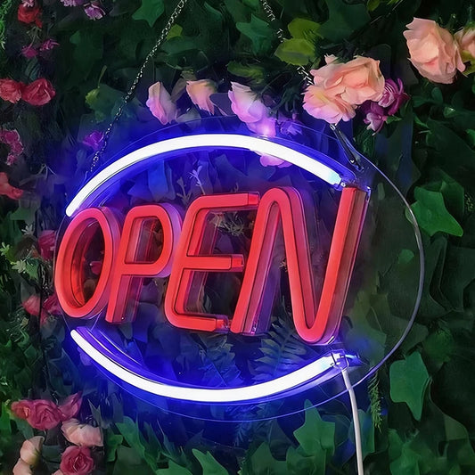 Neon 'OPEN' sign surrounded by flowers