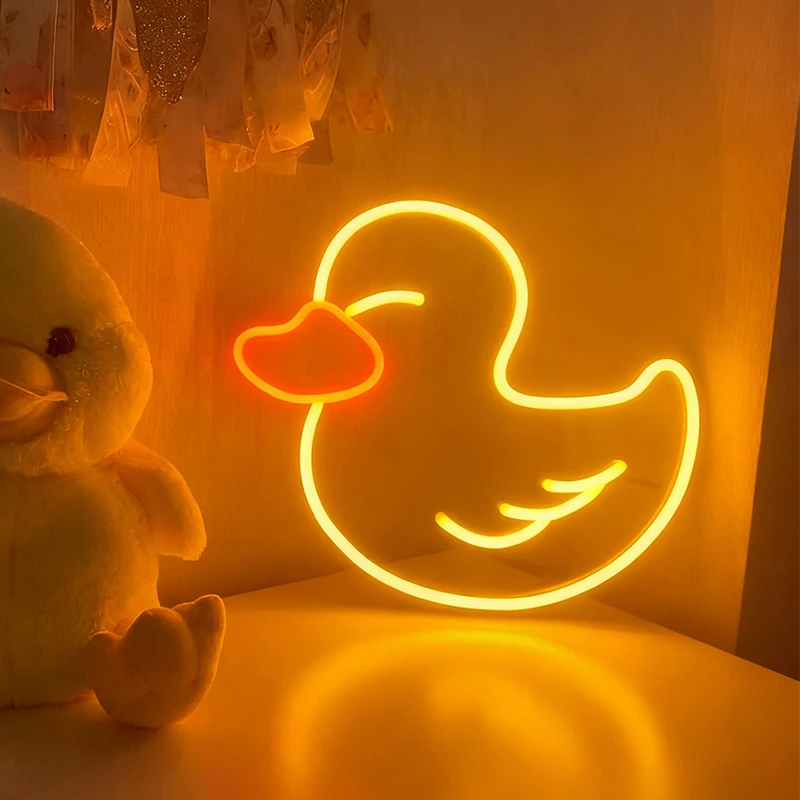 Neon duck sign and plush toy on a yellow background