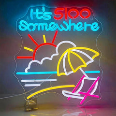 Neon sign with beach scene and 'It's 500 Somewhere' text on a dark background