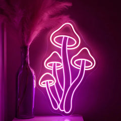 Neon mushroom light fixture on a dark background with a decorative bottle and feathers.