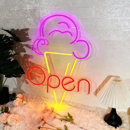 Neon sign with ice cream cone and 'Open' text on a textured wall with decorative elements.