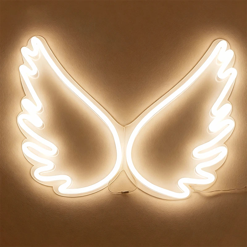Neon light shaped like angel wings on a beige background