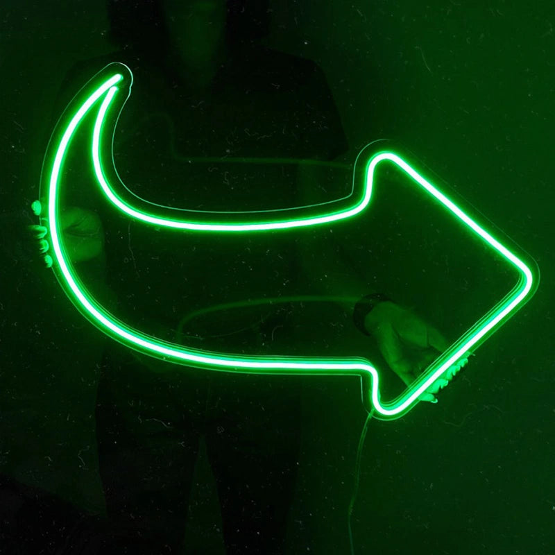 Neon green arrow-shaped light on a black background