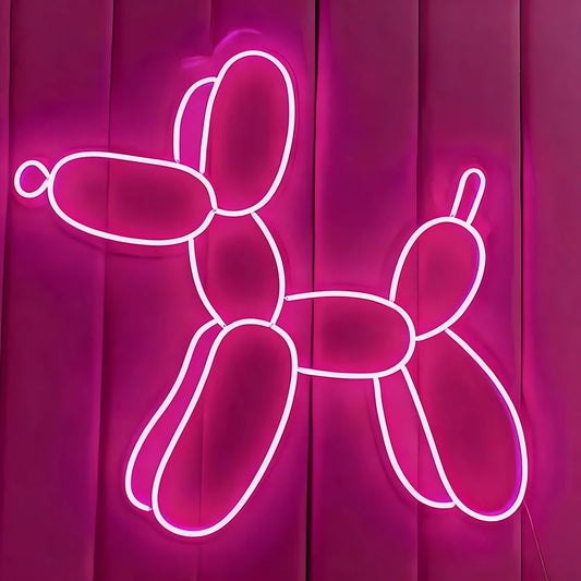 Neon hot pink balloon dog sculpture on a pink background