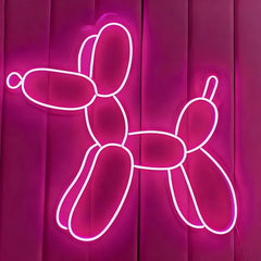 Neon hot pink balloon dog sculpture on a pink background