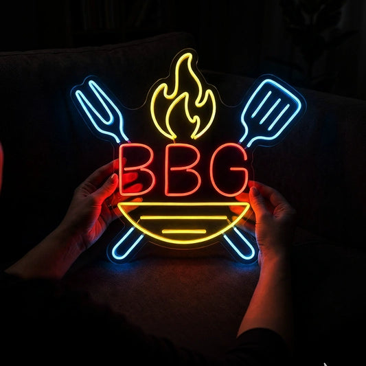 Neon sign with 'BBQ' and utensils held by hands against a dark background