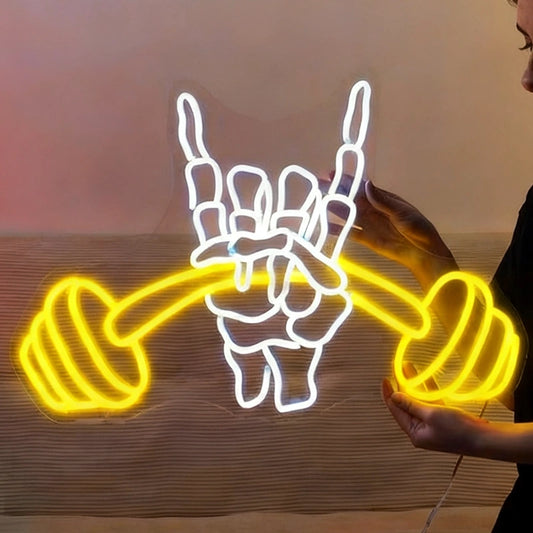 Neon sign of a skeleton hand holding dumbbells against a plain background