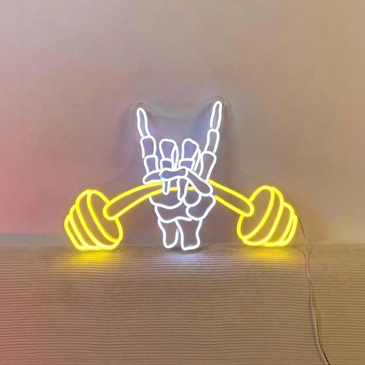 Neon light shaped like a barbell neon on a wooden surface.