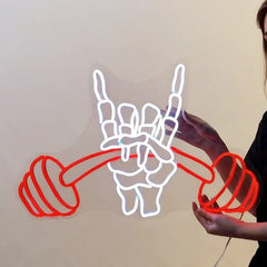 Neon sign of a hand holding a dumbbell against a plain background
