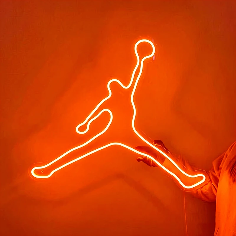 Neon outline of a jumping figure on an orange background