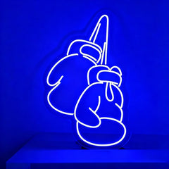 Neon sign of boxing gloves on a blue background