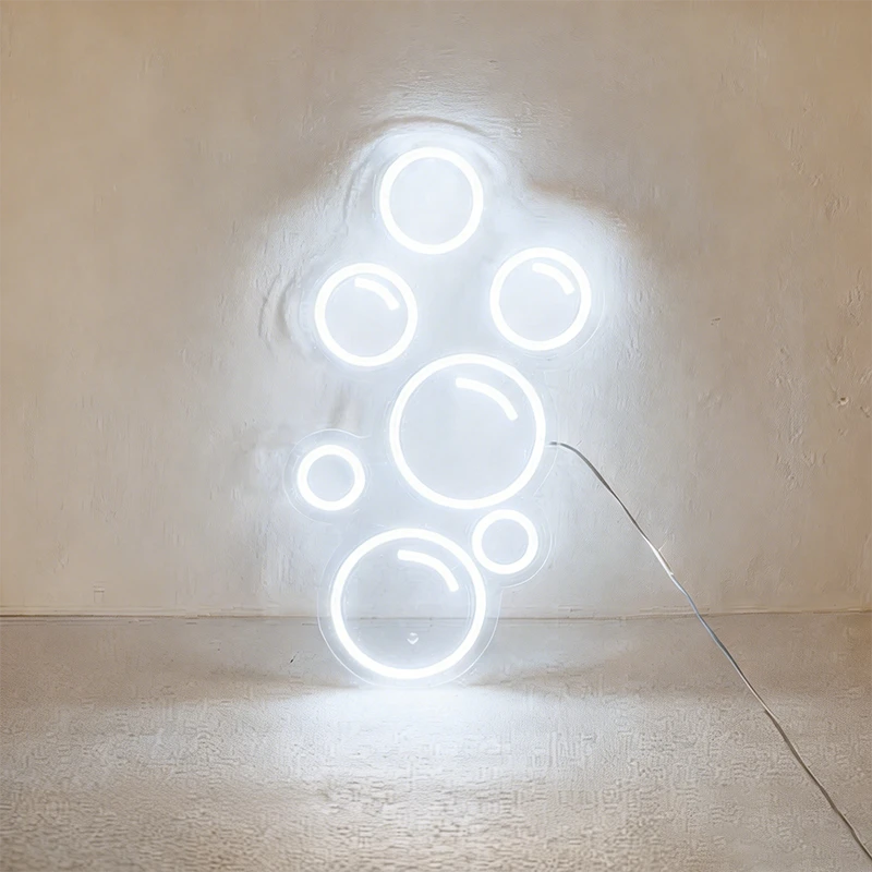 White neon light shaped like bubbles on a wall.