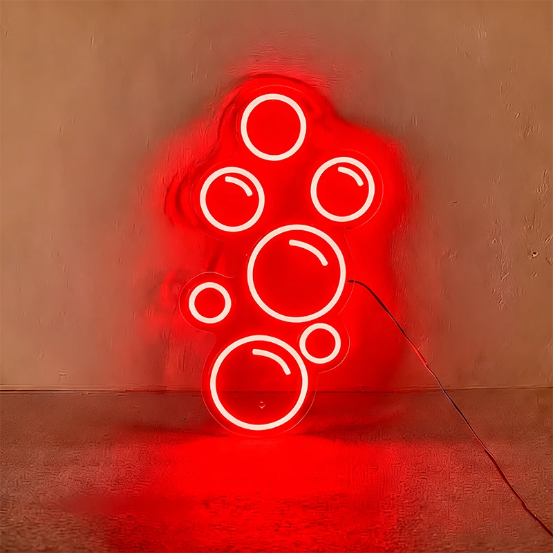 Red neon light shaped like bubbles on a wall.