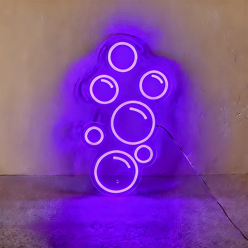 Purple neon light shaped like bubbles on a wall.