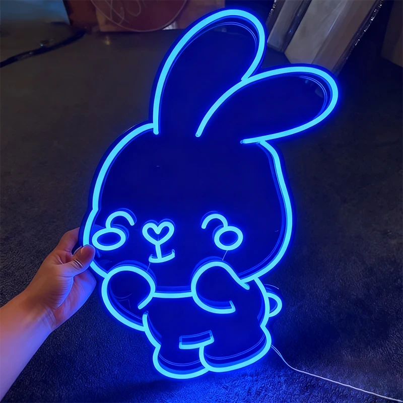 Neon sign shaped like a cartoon bunny with glowing blue outline.
