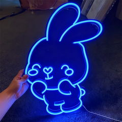 Neon sign shaped like a cartoon bunny with glowing blue outline.
