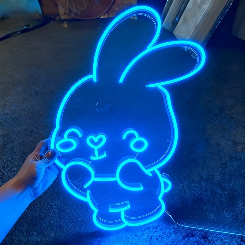 Neon light shaped like a cartoon character on a dark background