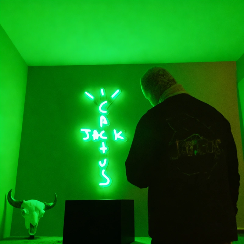 Green Cactus Jack LED neon sign glowing on a wall in a modern room, Travis Scott inspired neon light decor for gaming rooms, bedrooms, and music fans.
