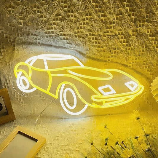 Neon light shaped like a car on a textured wall with decorative elements.