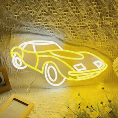 Neon light shaped like a car on a textured wall with decorative elements.
