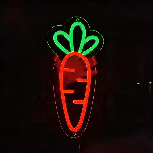 Neon sign of a carrot with a green top on a black background
