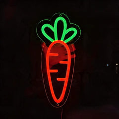 Neon sign of a carrot with a green top on a black background