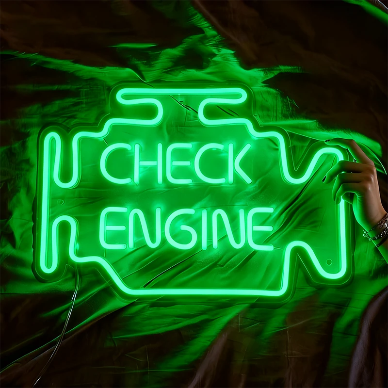 Green neon sign shaped like a car engine with 'Check Engine' text on a fabric background.