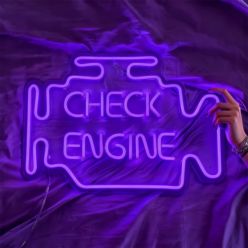 Purple neon sign shaped like a car engine with 'Check Engine' text on a fabric background.