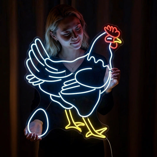 A neon sign featuring a chicken and an egg held by a woman against a dark background.