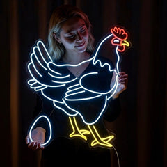 A neon sign featuring a chicken and an egg held by a woman against a dark background.